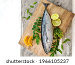 Closeup view of Tuna fish decorated with fruits and herbs on a wooden background,Selective focus.