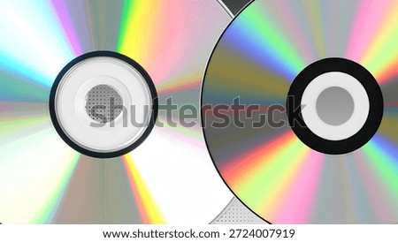 Close-up view of two CDs with rainbow reflections and light beams radiating from their centers