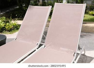 Close-up view of two comfortable sun loungers positioned near a crystal-clear swimming pool. Perfect visual for luxury vacations, resort advertising, wellness retreats, hospitality marketing and summer holiday promotions.