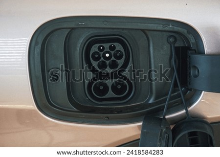 Close-up view of a type2 socket on ev car , showcasing auto technology and photography equipment.