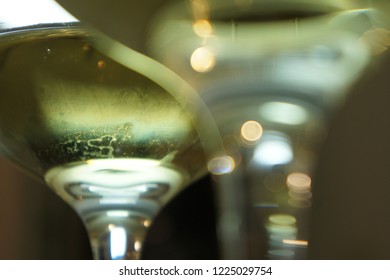 A close-up view under wine glasses with white wine