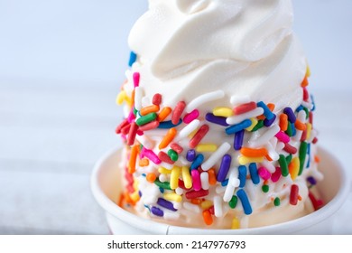 A Closeup View Of A Vanilla Frozen Yogurt, Featuring Rainbow Sprinkles Toppings.