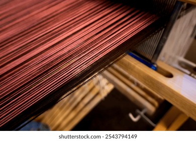Closeup view of a vibrant stack of Thai ethnic textile fabric, showcasing rich colors and textures, likely in a local handmade from craftsmanship process