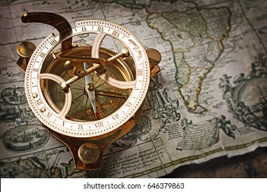 Close-up view of a vintage compass on an old retro map. The map used for background is in Public domain. Map source: New York Public Library - Shutterstock ID 646379863