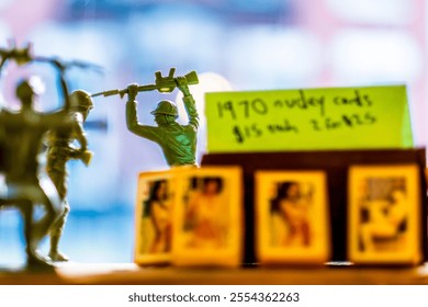 Close-up view of vintage toy soldiers alongside 1970s trading cards. The colorful, blurred background adds a sense of nostalgia, evoking childhood memories and retro collectibles charm. - Powered by Shutterstock