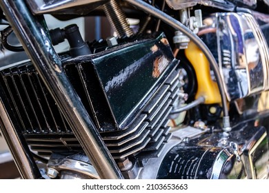 Close-up View Of Vintage Two Strokes Motorcycle Black Engine On Metal Pipe Frame Showing The Detail Of The Mechanism And Parts Such As A Cylinder Head , Fuel Tank And Hose. 