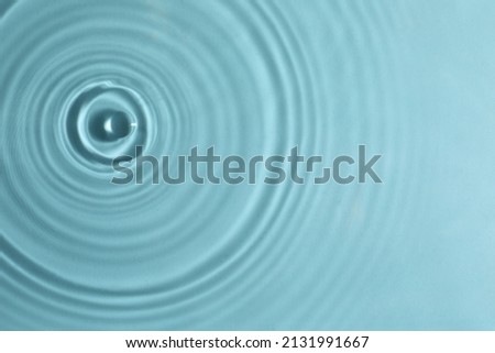 Closeup view of water with circles on turquoise background