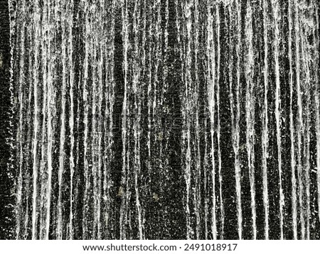 A close-up view of water flowing down a textured surface, resembling a waterfall.