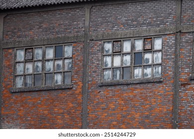 Close-up view of weathered windows on an old brick building, showcasing vintage architectural details. - Powered by Shutterstock