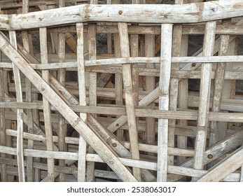 close-up view of weathered wooden structure with lattice pattern, showing intricate details and natural wear, made from dried bamboo for old home fence - Powered by Shutterstock