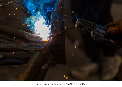 Close-up View Of The Welding Fume. The Welder Welds The Fillet. Fillet Weld Refers To The Process Of Joining By Combining Two Pieces Of Metal, Whether They Are At An Angle Or At An Angle.