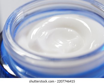 Closeup View Of White Moisturiser Cream In Blue Tub