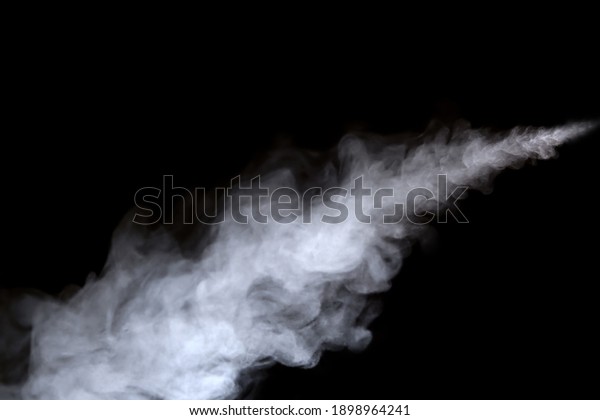 Close-up view of white water vapor\
with spray from the humidifier. Isolated on black\
background
