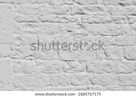 Close-up view of whitewashed brick wall, rough texture and irregularities of bricks. Surface highlights natural rustic character of stonework, commonly found in traditional Mediterranean architecture