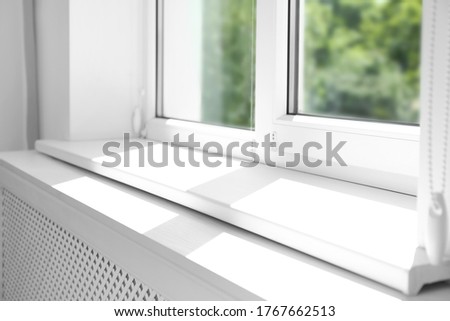Closeup view of window with empty white sill