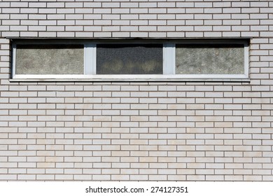 close-up view of a window in a white brick building
