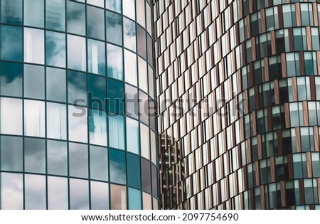 A close-up view of the windows of the modern building.  Reflection of another building in the background. Vertical and horizontal lines. Abstract color wallpaper. Bratislava, Slovakia
