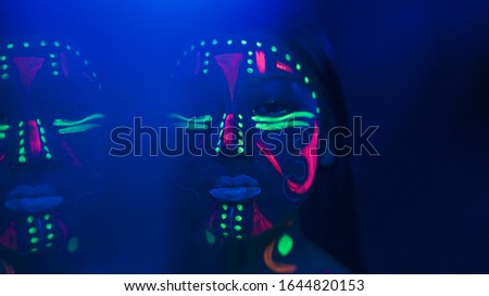 Close-up view of woman with fluorescent make-up 