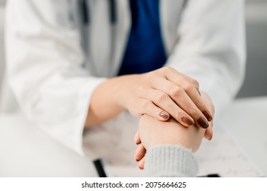 Close-up view of woman professional doctor touching hand patient reassuring concern medication and treatment method with a patient at room hospital, medical health care concept
