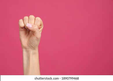 Closeup View Of Woman Showing Fist As Girl Power Symbol On Pink Background, Space For Text. 8 March Concept