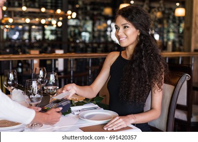 Close-up View Woman Using Contactless Credit Card On Pos Terminal In Restaurant