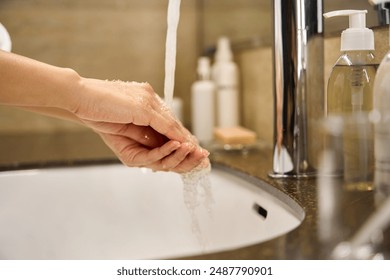 Close-up view woman washing her hands under running water - Powered by Shutterstock