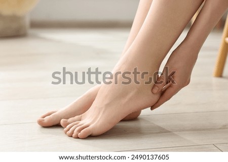 Closeup view of woman`s groomed feet after care procedure on floor