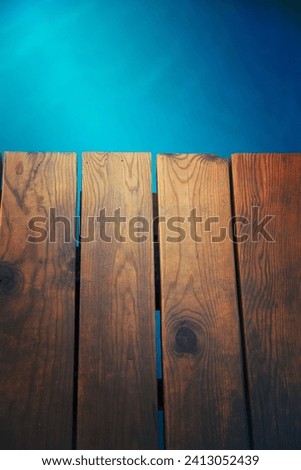 Closeup view of wooden pier with blue sea backdrop