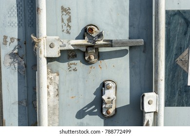 Closeup view of the worn door handle lock of an intermodal shipping container.