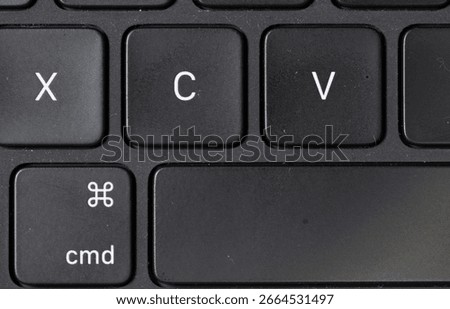 Close-up view of X C V keys and command key on black keyboard