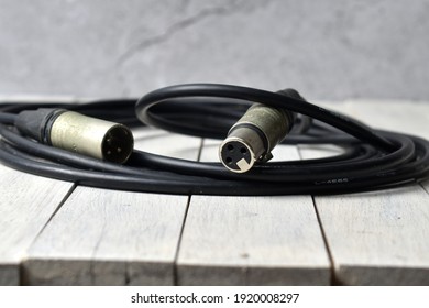 Close-up view of the XLR cable on an old wooden surface, perfect for presentations(Focus selection).
