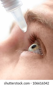 Closeup View Of Young Man Applying Eye Drop