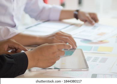 Close-up view of young ui development team working together in office.