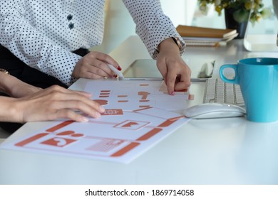 Close-up view of young ui development team working together in office.	