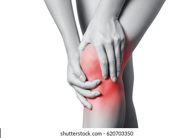 Closeup View Of A Young Woman With Knee Pain. Isolated On White Background. Black And White Photo With Red Dot.