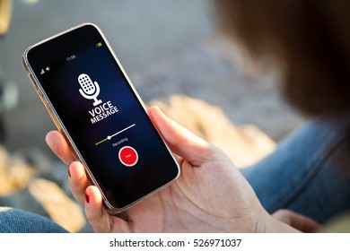 Close-up View Of Young Woman Recording Voice Message On Her Mobile Phone. All Screen Graphics Are Made Up.