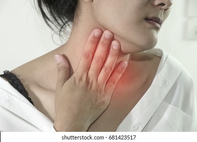 Closeup view of a young woman with Sore throat or pain on neck or thyroid gland. isolated on white background. People body problem concept