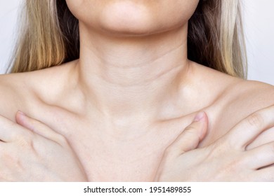 A close-up view of a young woman's neck and chest. Lines on the neck. Wrinkles, age-related changes, rings of Venus