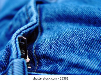 Closeup view of a zipper on a pair of blue jeans