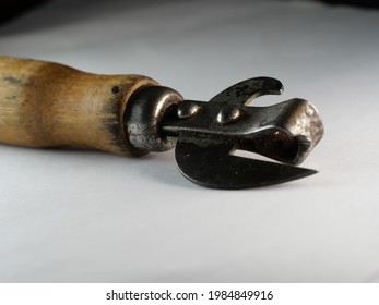 A Closeup Of Vintage Can Opener Isolated On An Empty Surface