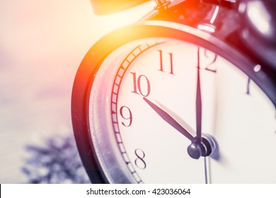 closeup vintage clock selective focus at number 10 o'clock with sun light vintage color tone for postcard. - Powered by Shutterstock - Get 15% off with code: PIKWIZARD15