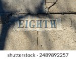 Closeup of vintage Eighth Street tile sign (not art) on the sidewalk in the Garden District of New Orleans, LA, USA