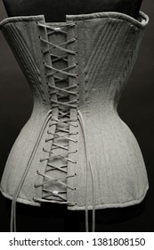 Closeup of vintage female corset on dark studio background