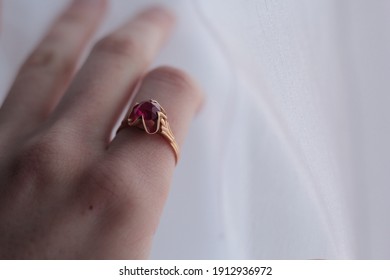 Closeup Of A Vintage Gold Ring With A Ruby Worn By A Woman.