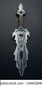 Closeup Of Vintage Metal Sword Decorated With Gems On Black Background