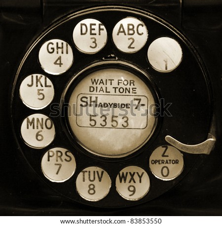 Closeup of vintage telephone dial in sepia.