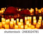 closeup of violin with lots of candles for design purpose 