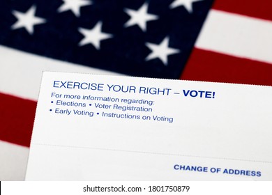 Closeup Of Voter Registration Identification Card With American Flag In Background. Concept Of Right To Vote, Voter Suppression And Election