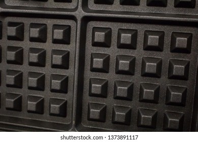 A Closeup Of A Waffle Iron Grill Surface