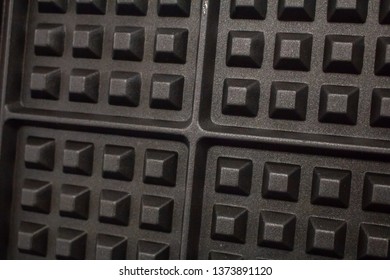 A Closeup Of A Waffle Iron Grill Surface